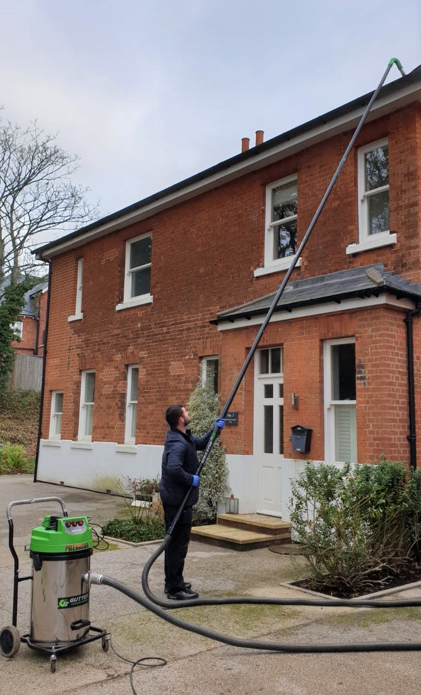 High-reach gutter vacuum in use